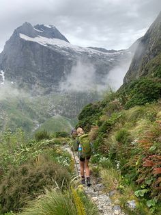 a woman hiking up the side of a mountain