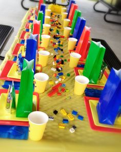 a table with cups and legos on it