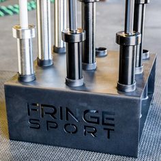 an assortment of metal tubes on top of a black box with the word fringe sport printed on it