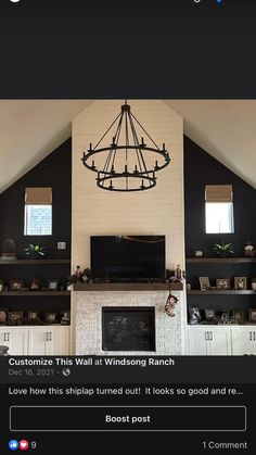 the living room is decorated in black and white with a chandelier hanging from the ceiling