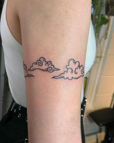 a woman with a cloud tattoo on her arm