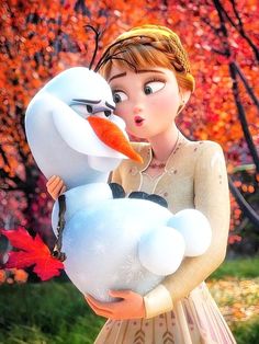 a girl holding a snowman in her arms