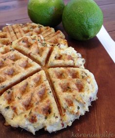 two limes are sitting next to some waffles on a table