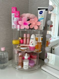 a bathroom counter with various beauty products on it