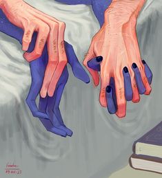 two hands holding each other on top of a bed next to a book and pillow