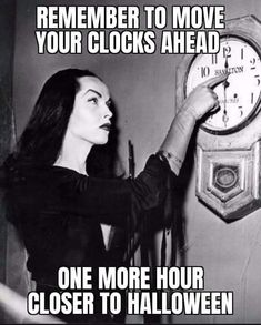 a woman in black dress holding up a clock with caption saying, remember to move your clocks ahead one more hour closer to halloween