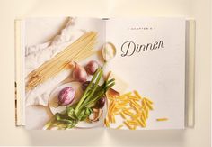 an open cookbook with pasta, vegetables and other items on the cover is shown