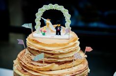 a stack of pancakes is decorated with figurines