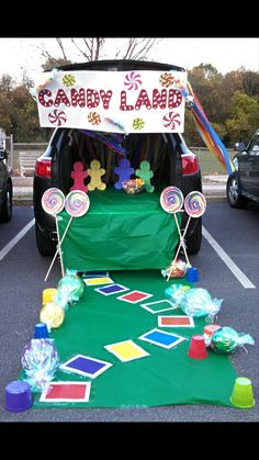 a car is parked in a parking lot with candy land decorations