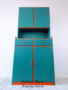 a blue cabinet with an orange stripe on the top and bottom, against a white wall