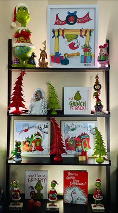 the grinch is back shelves are filled with christmas cards and other holiday decorations, including dr seuss's hat