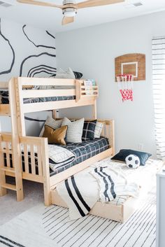 a bedroom with two bunk beds and a basketball hoop on the wall above it,