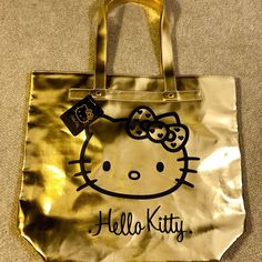 Nwt Authentic Sanrio Hello Kitty Gold Soft Pleather Tote Bag. Features Large Interior Pocket With Super Cute Hello Kitty Lining. Gussets On The Bottom So You Can Stuff The Bag With So Much More! Very Lightweight With Reinforced Shoulder Straps That Are 8” Higher Than The Top Of The Bag. Measures 17”X15”. Ships Quickly From A Smoke Free But Dog Friendly Home. Cheap Hello Kitty Print Rectangular Shoulder Bag, Sanrio Bags, Sanrio Bag, Cute Hello Kitty, Dog Friendly, Womens Tote Bags, Dog Friends, Hello Kitty, Reusable Tote Bags