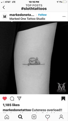 a small tattoo on the arm of a woman with an owl sitting on top of it