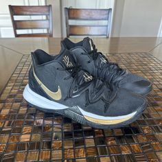 Elevate your game with these stylish Nike Kyrie 5 sneakers in black and metallic gold. Designed for men who want to make a statement on the court, these sneakers have a sleek and modern look that will surely turn heads. The black colorway is accented with hints of metallic gold, giving these shoes a luxurious and high-end feel. Used for one season of basketball still in great condition and stylish Nike Kyrie 5, Kyrie 5, Nike Kyrie, Black Metallic, The Court, Metallic Gold, The Black, Gold Metal, Athletic Shoes