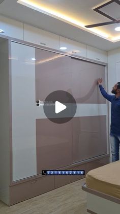 a man standing next to a sliding glass door in a room with white walls and wood floors