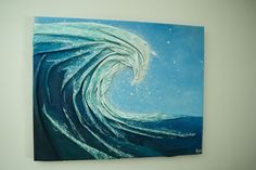 a painting on the wall of a wave in the ocean with blue sky and white stars