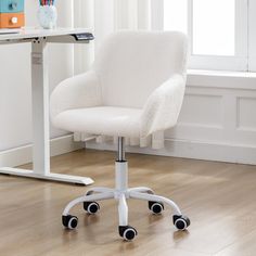 a white office chair sitting on top of a hard wood floor