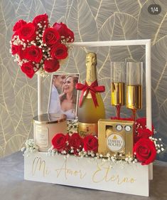 a table topped with red roses and champagne