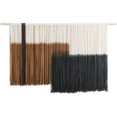 two different colors of yarn hanging on a wall with one black and the other white