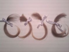 three pieces of hair with bows on them