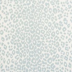 a blue and white animal print wallpaper with small spots on the back of it