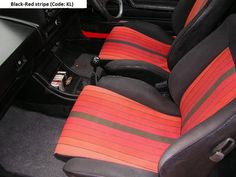 the interior of a car with red and black stripes on it's seat covers