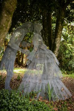 two sculptures in the middle of a forest