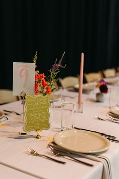 the table is set with place cards and silverware