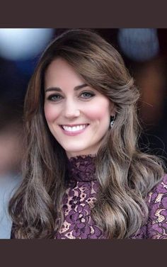 a woman with long hair wearing a purple dress