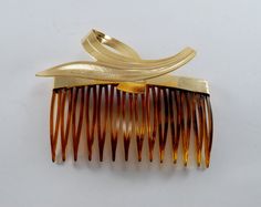 "For sale is a vintage hair comb. This hair comb is brown plastic with a gold tone metal topper. The hair combs measure 2 3/4\" x 2 1/4\". Please note the combs or toppers could have scratches blemishes, spotting, tarnishing, or imperfections in the finish. The combs are signed \"Made USA\". New treasures added all the time. Check back often!" Vintage Hair Comb, Back Combing, Fashion 1970s, Vintage Hair Combs, Tortoise Color, Vintage Hair, Hair Combs, Big Hair, Vintage Hairstyles