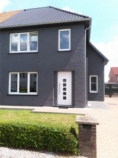 a grey house with white doors and windows