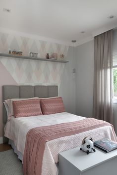 a bedroom with a bed, nightstands and shelves on the wall next to it