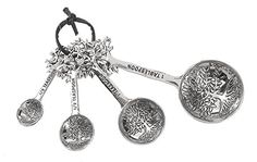 four spoons with different designs on them are hanging from a cord that is attached to a keychain