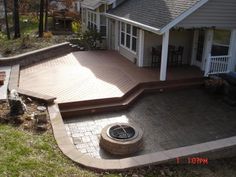 a patio with a fire pit in the middle