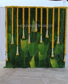 the backdrop is made up of green leaves and yellow flowers with white tassels hanging from them