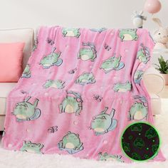 a pink blanket with green hippos on it