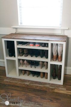 a white shelf filled with lots of shoes