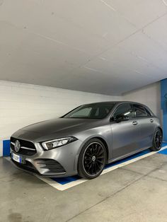 a silver car parked in a parking garage