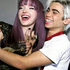 two people are hugging and smiling for the camera