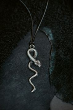 Introducing the exquisite Lilith Goddess Snake Pendant, a captivating piece of jewelry that beautifully combines mythology and craftsmanship. This unique pendant is a stunning homage to the enigmatic figure of Lilith, intricately designed to reflect her symbolic power and allure. Crafted from nickel patina, this pendant features a meticulously detailed snake, elegantly coiled and poised for action. The snake, a potent symbol of transformation and wisdom, embodies the essence of Lilith herself. I Lilith Jewelry, Lilith Goddess, Witchy Necklace, Snake Pendant, Modern Witch, Snake Jewelry, Feminine Power, Wooden Jewelry Boxes, Inspired Jewelry