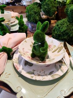 a table set with plates, napkins and bunny ears