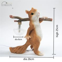 a squirrel figurine holding a light bulb on a tree branch with the measurements