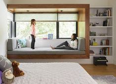 a girl is standing on the window sill in her bedroom