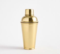 a shiny gold cocktail shaker on a white background