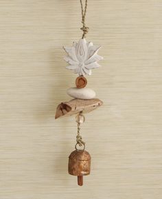 a wind chime hanging from a rope with shells and seashells on it