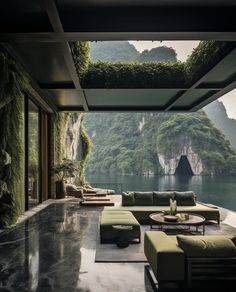 a living room filled with furniture next to a large window covered in greenery and mountains