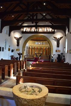 the inside of a church with pews and statues