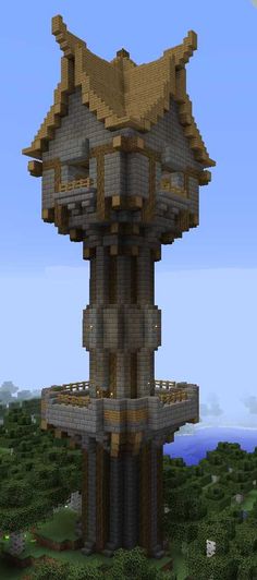 a very tall tower sitting in the middle of a forest