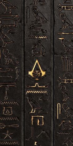 egyptian hieroglyphics and symbols on black paper